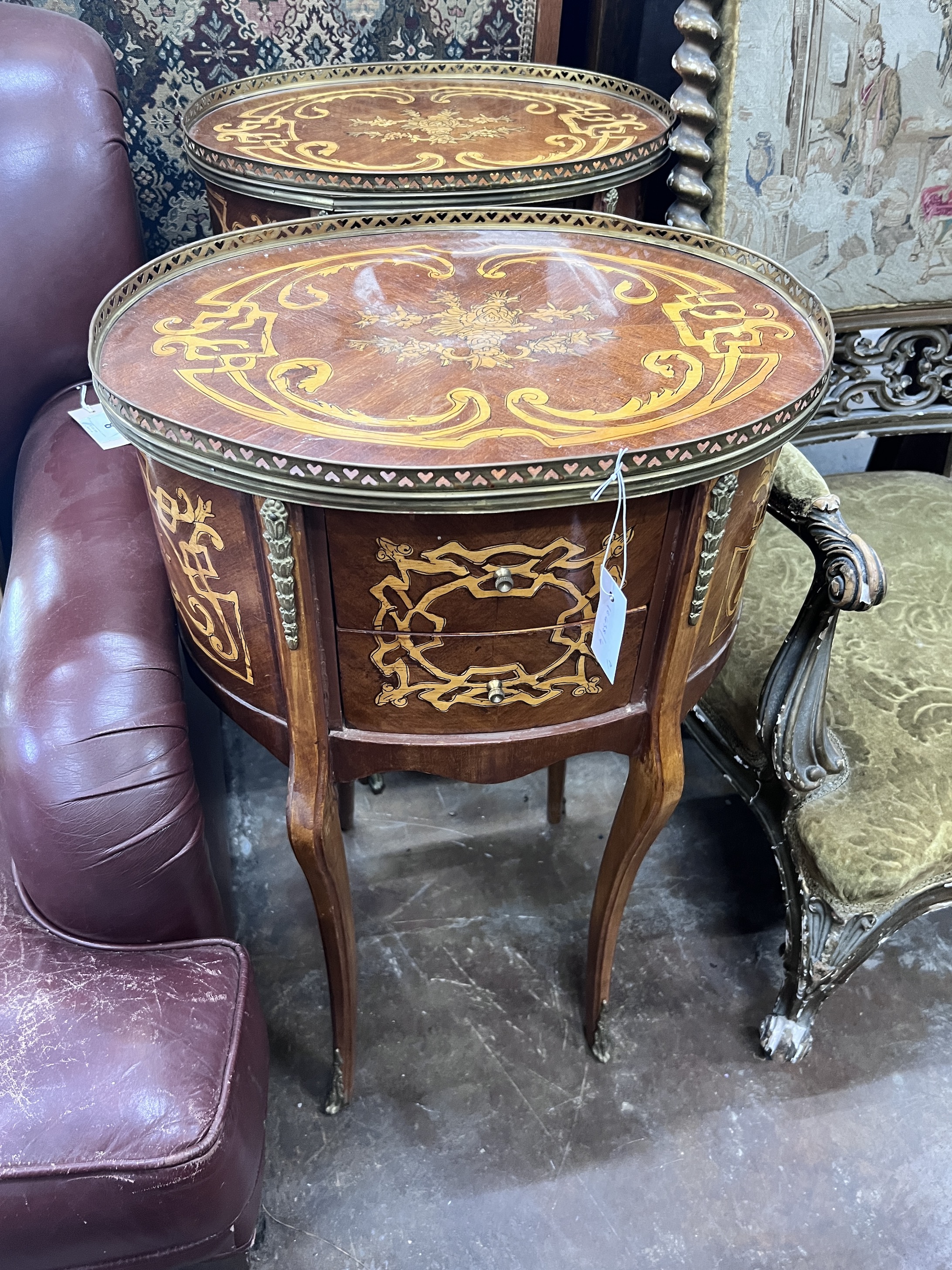 A pair of reproduction Louis XV style oval marquetry inlaid bedside chests, width 47cm, depth 36cm, height 77cm